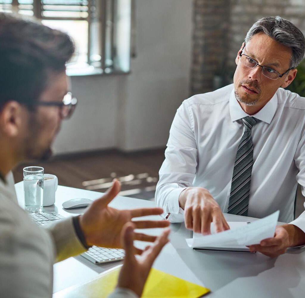 member-human-resource-team-talking-with-candidate-while-reviewing-his-resume-during-job-interview-office-compressed
